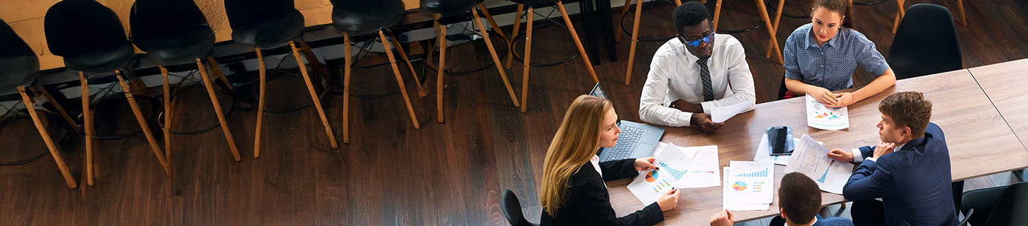 Government employees in a training session or completing compliance training on computers